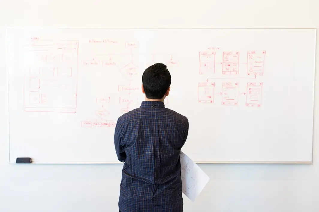Ingeniero de software analizando código heredado en pantalla mientras moderniza sistema empresarial en oficina chilena